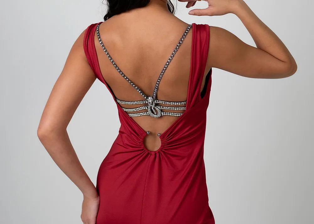 Woman wearing luxury lingerie bra on a backless dress on a gray background